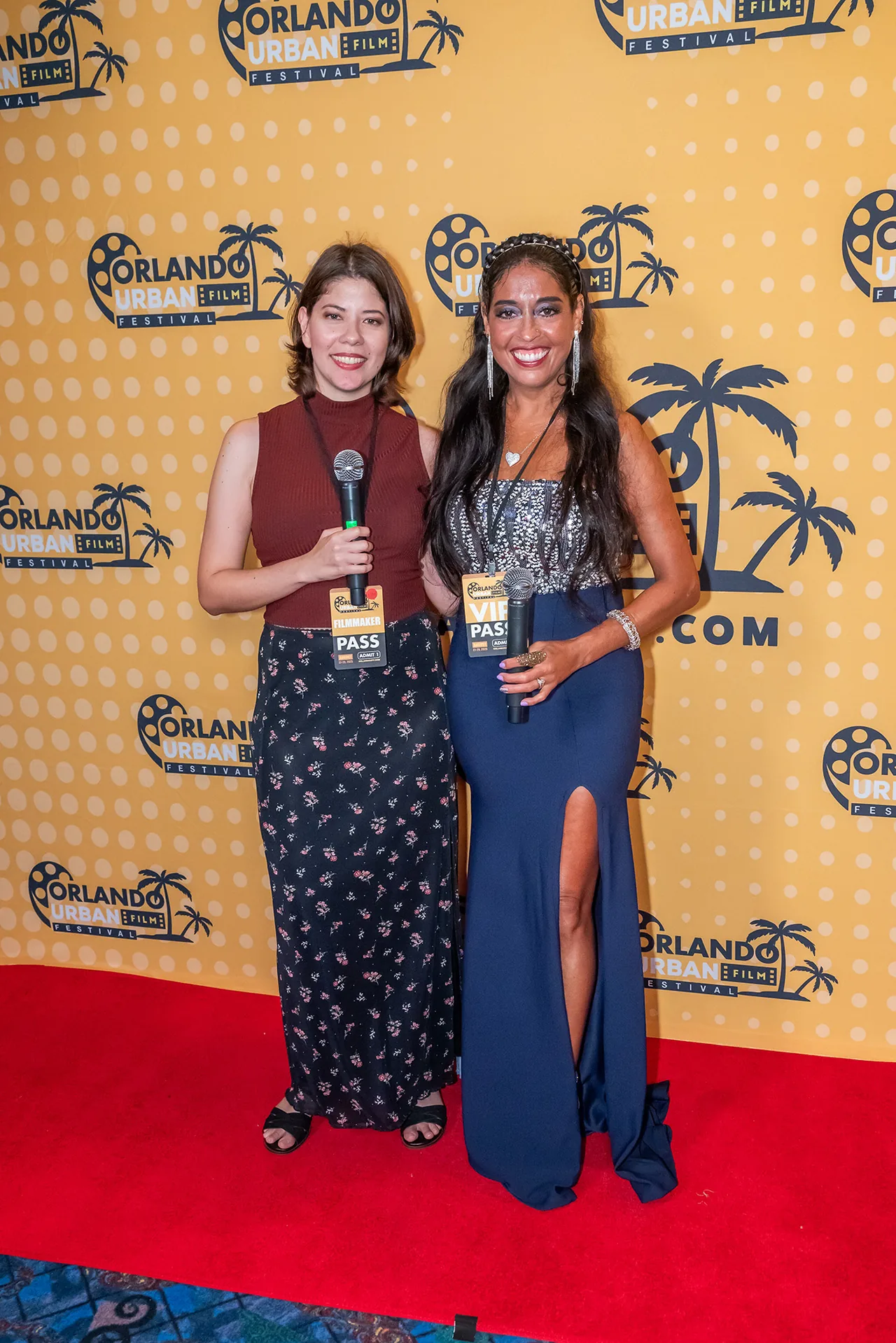 Two hosts with microphones conducting a red carpet interview