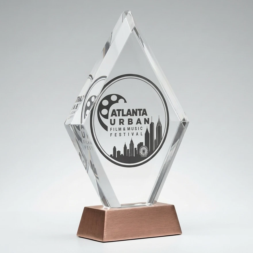 The Hattie Awards crystal statue, etched with the Atlanta Urban Film & Music Festival mark, on a rose-gold base
