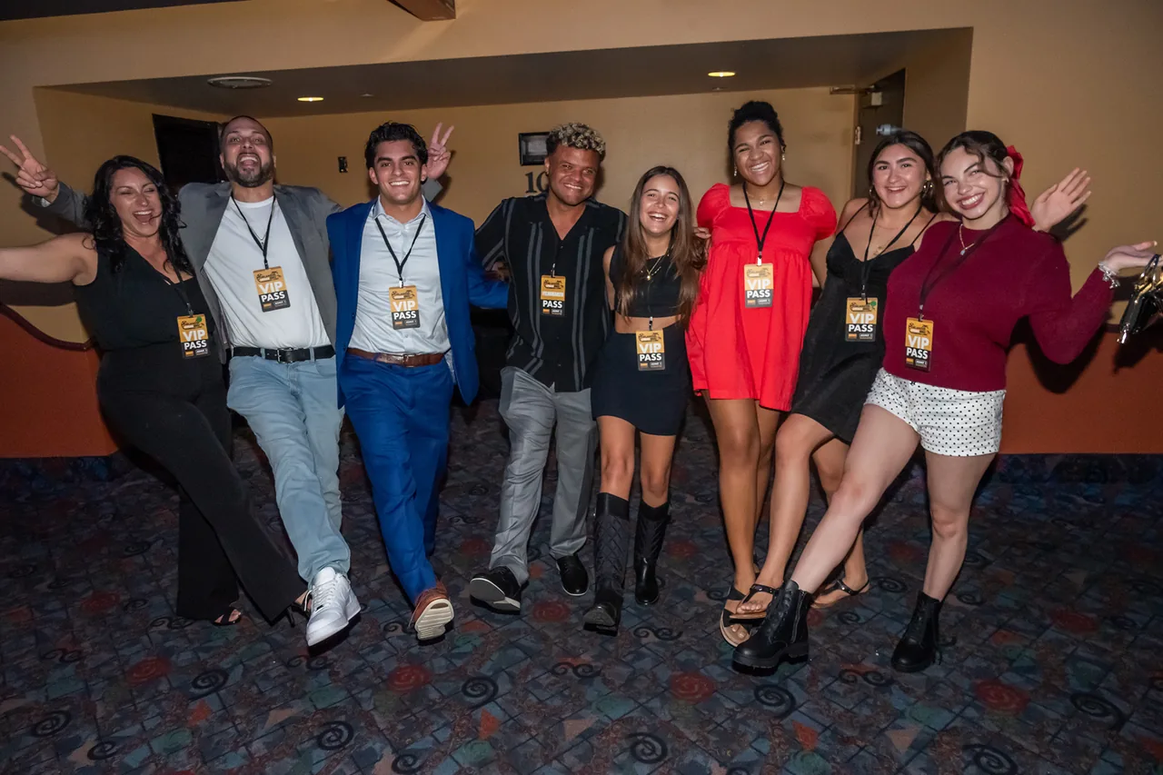 A crowd of festival-goers laughing and celebrating together in the cinema lobby