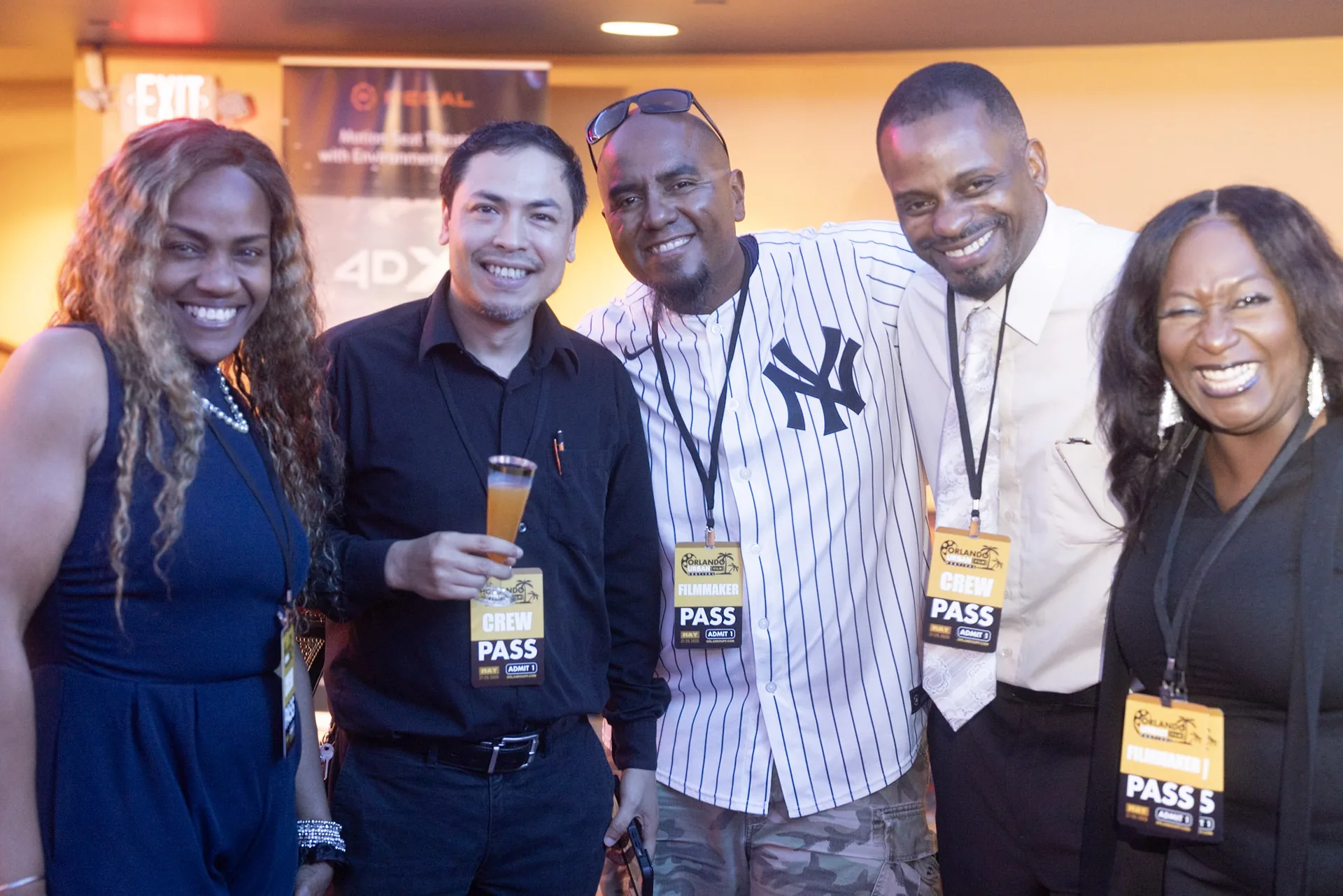 Five festival-goers laughing together at the opening reception