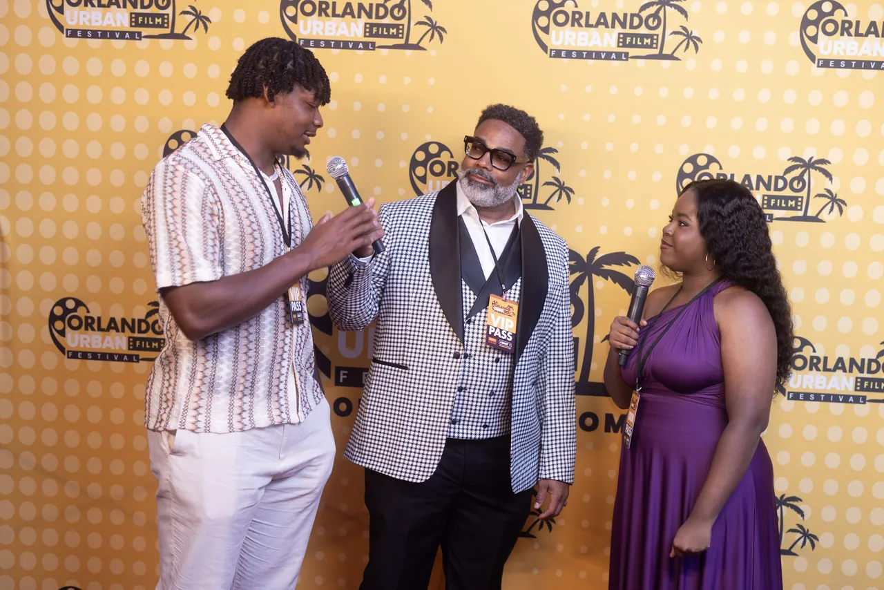 Three guests being interviewed together on the red carpet